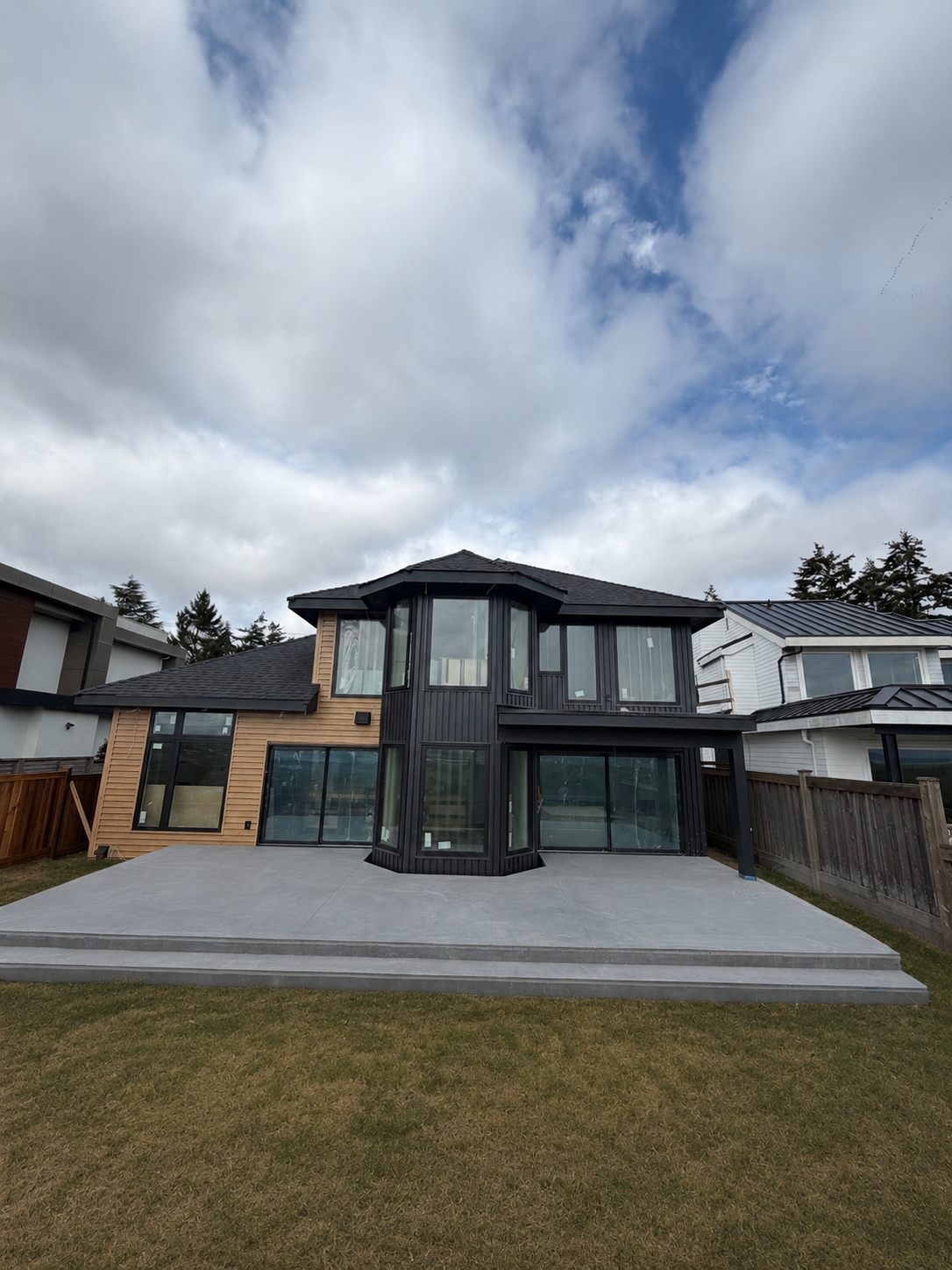 A completed TAKL Services project — a modern two-storey home with black cladding and windows