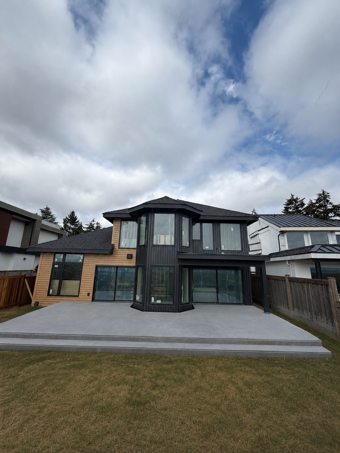 A completed TAKL Services project — a modern two-storey home with black cladding and windows