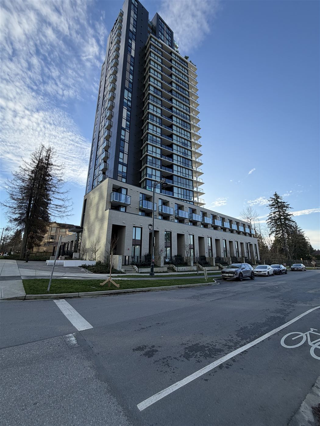 Modern strata residential building along a Lower Mainland streetscape, one of the property types TAKL Services maintains